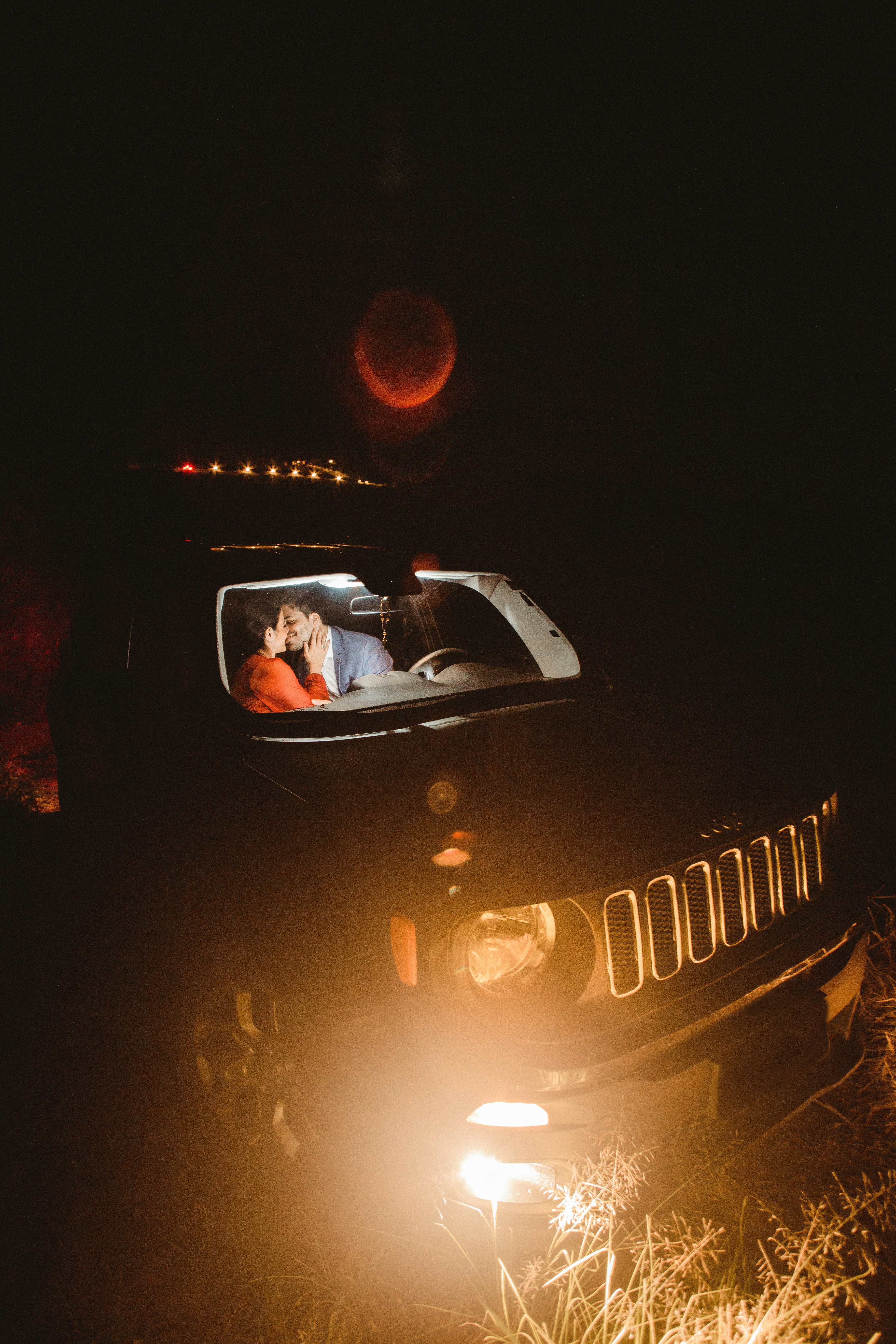 man in black jacket driving a car